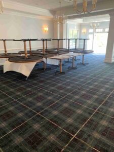 Community Center Renovation update – new carpet installation close up with staged tables