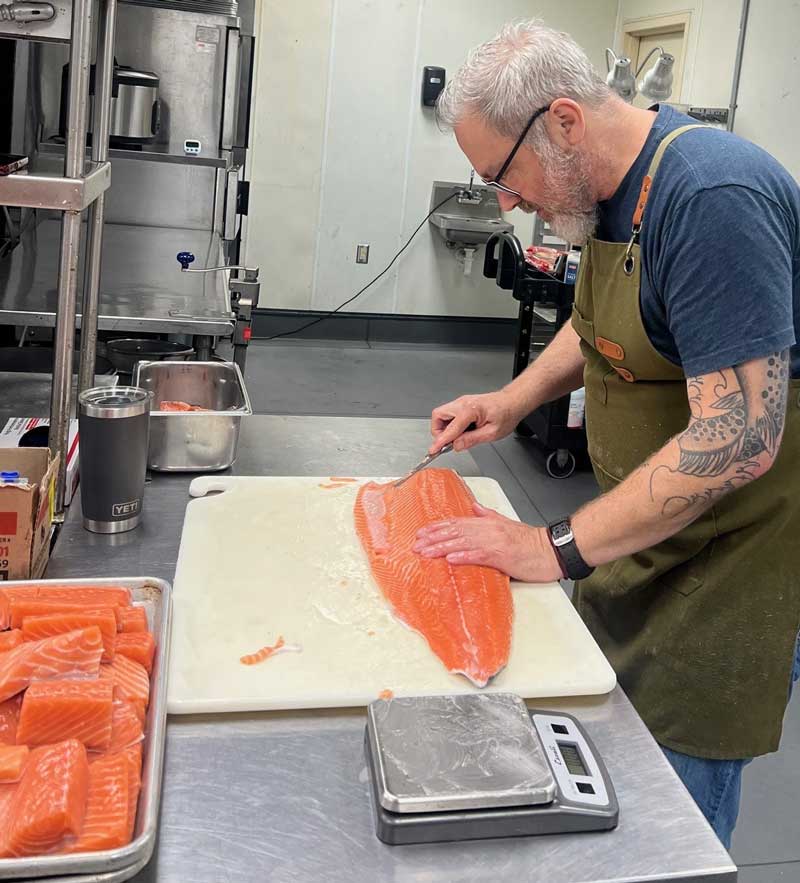 Chef Brendan Keegan preparing fish filets
